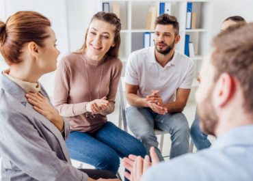 depositphotos_253591026-stock-photo-group-people-sitting-chairs-applauding